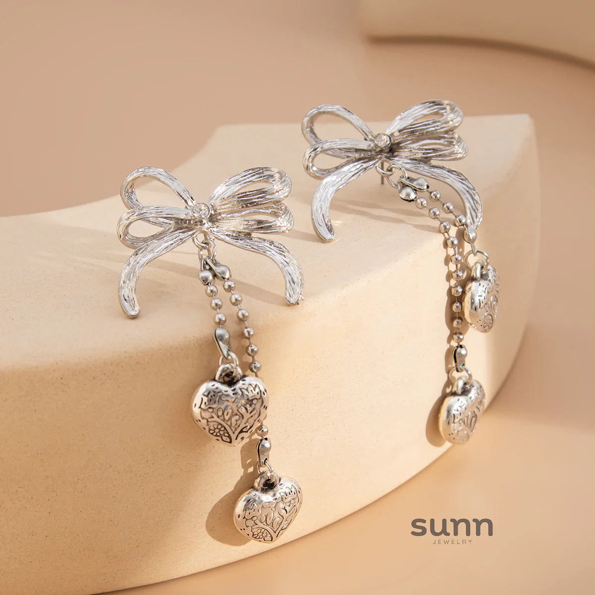 Jodi Heart Bow Tassel Studs